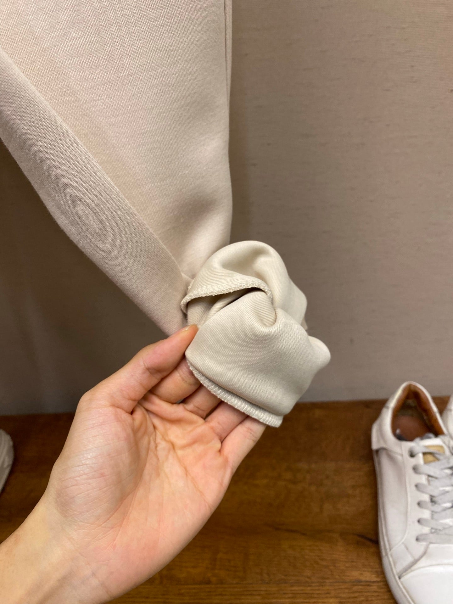 Cream jogger cuff with elastic hem and gathered fabric, close-up