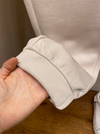 Cream pants cuff and hem stitching with elastic band, close-up