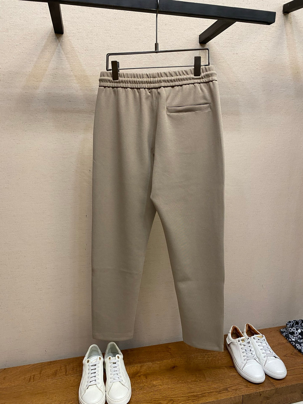 Beige drawstring sweatpants with front pocket and elastic waistband