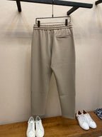 Beige drawstring sweatpants with front pocket and elastic waistband