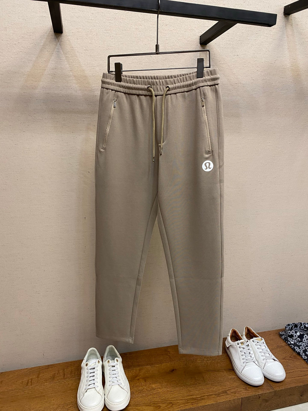 Beige drawstring sweatpants with elastic waistband and side pockets