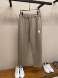 Beige drawstring sweatpants with elastic waistband and side pockets