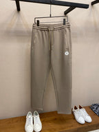 Beige drawstring sweatpants with elastic waistband and side pockets