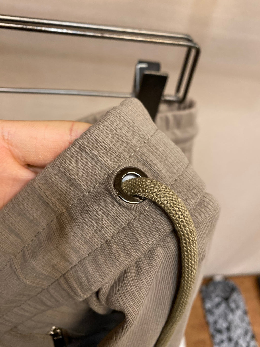 Beige fabric drawstring with metal grommet and braided cord