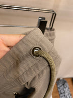 Beige fabric drawstring with metal grommet and braided cord