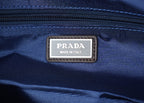 Prada Made in Italy leather patch label on dark-blue nylon bag