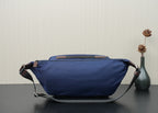 Prada dark-blue nylon waist bag with top handle and adjustable strap