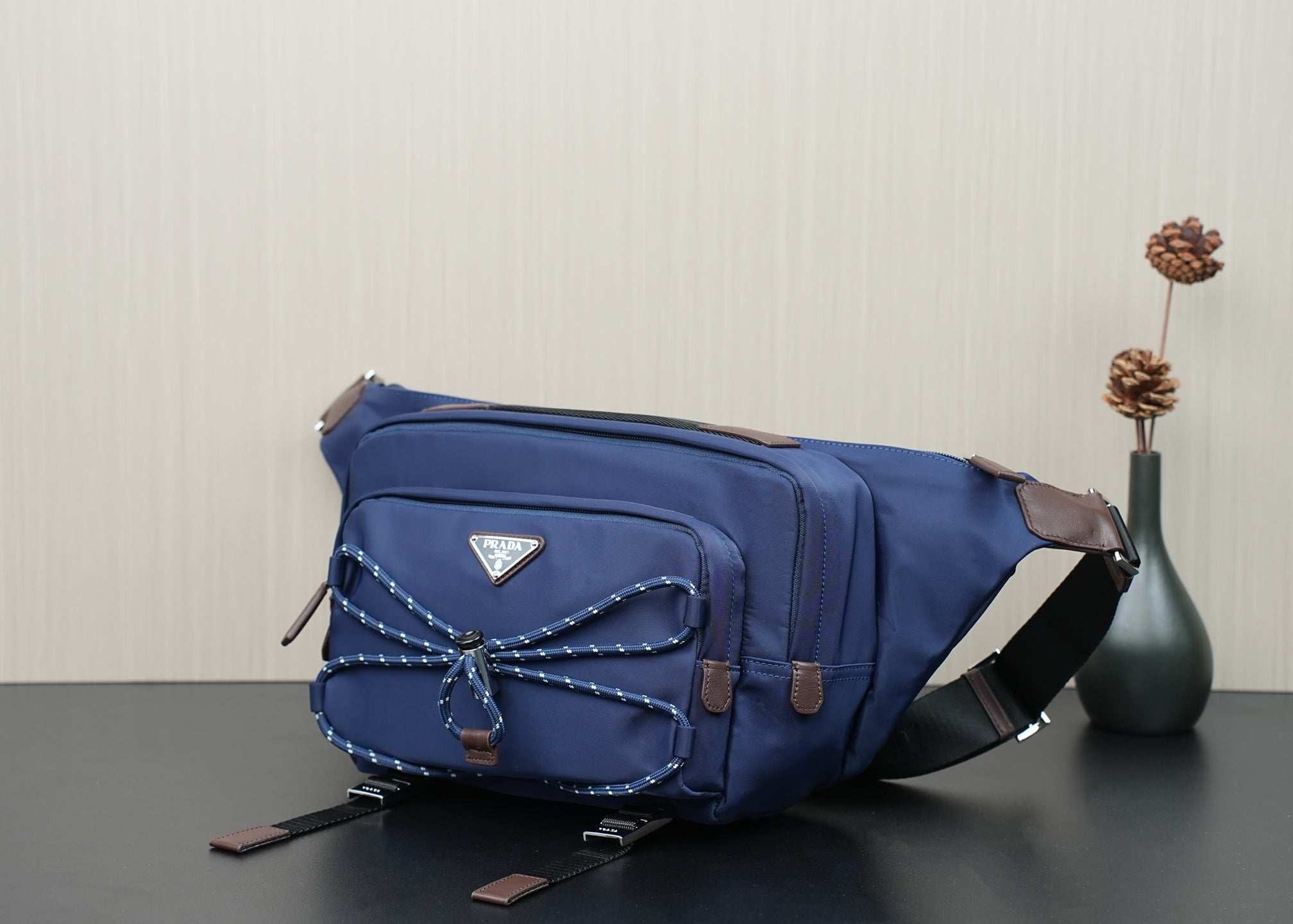 Prada dark-blue crossbody bag with adjustable shoulder strap and front logo triangle