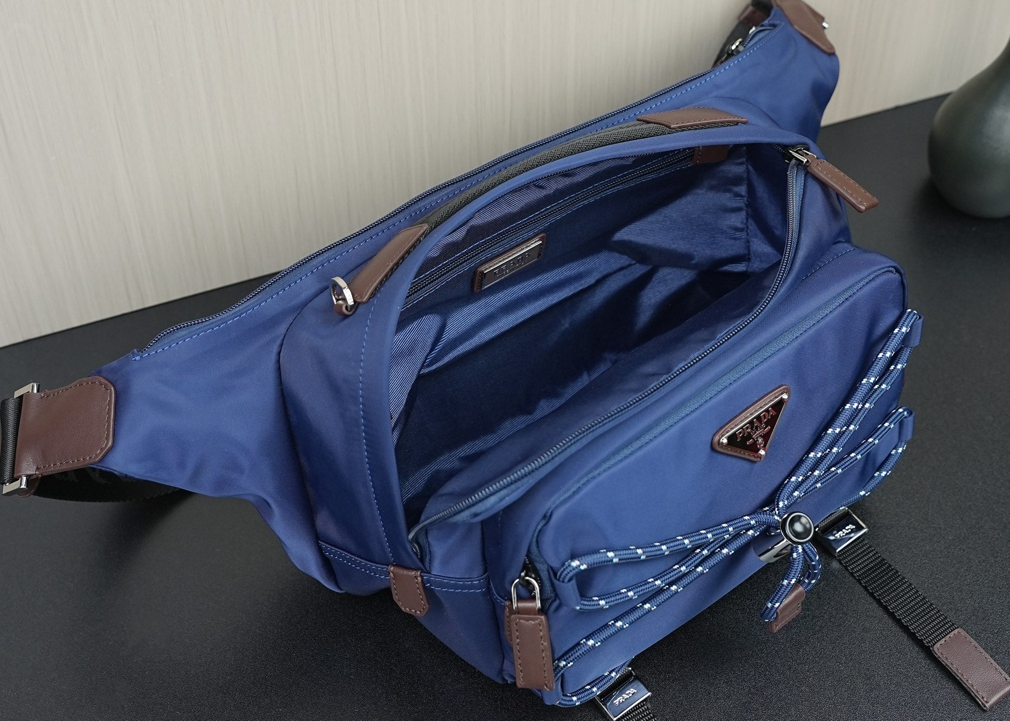 Prada dark-blue nylon bag with open top, inner pocket, and adjustable shoulder strap