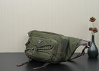 Green Prada bag side view with front patch, stud accents, and adjustable strap ends.