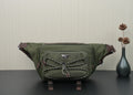 Green Prada bag with front logo plaque, quilted strap detail, and zipper closure.