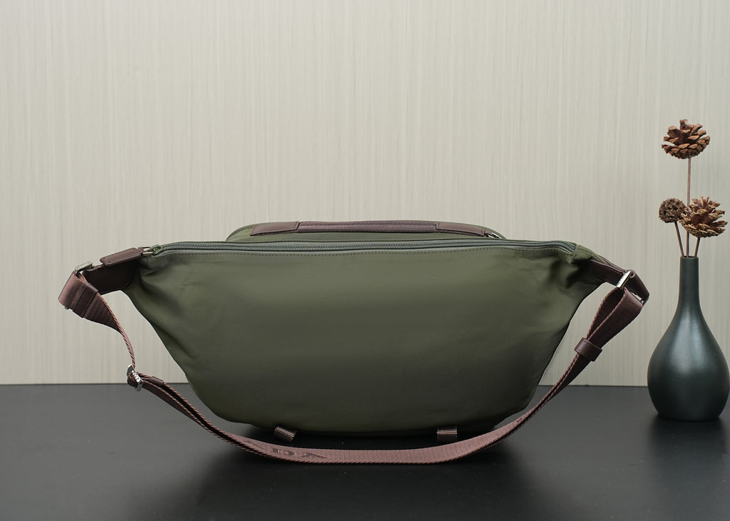 Green Prada bag back view with top handle tabs and zippered back panel.
