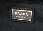 Made in Italy label patch on black fabric belt bag.