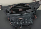 Black belt bag interior with zipper pocket, logo plaque, and fabric strap.