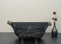 Prada belt bag in black with front logo plaque, braided trim, and adjustable straps.