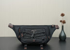 Prada belt bag in black with front logo plaque, braided trim, and adjustable straps.