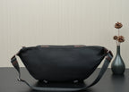 Black belt bag with adjustable crossbody strap and side buckle hardware.