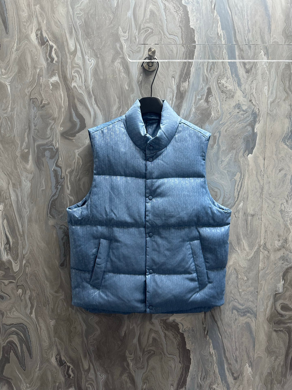 Blue long puffer vest with stand collar and snap-front closure