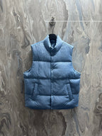 Blue long puffer vest with stand collar and snap-front closure