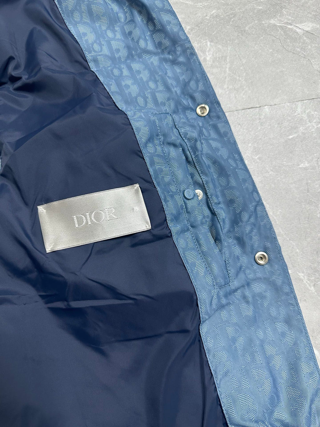 Blue long puffer vest with Dior logo label on inner chest