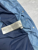 Blue puffer vest interior with printed size tag near snap buttons