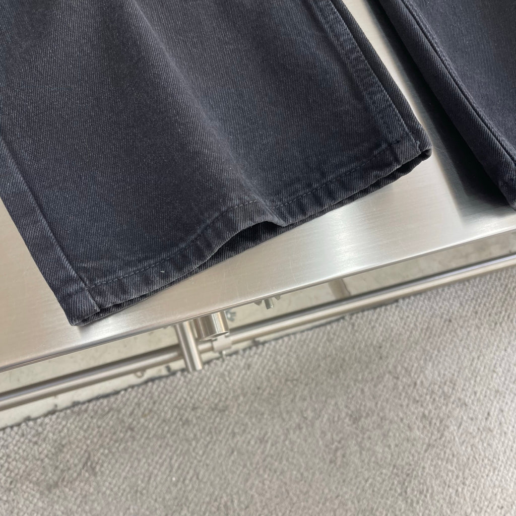 Dark denim pants hem with wide leg opening
