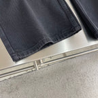 Dark denim pants hem with wide leg opening