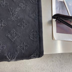 Dark denim pants leg with tonal embroidered monogram motifs