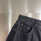 Dark denim pants front with patch pockets, belt loops, and snap buttons