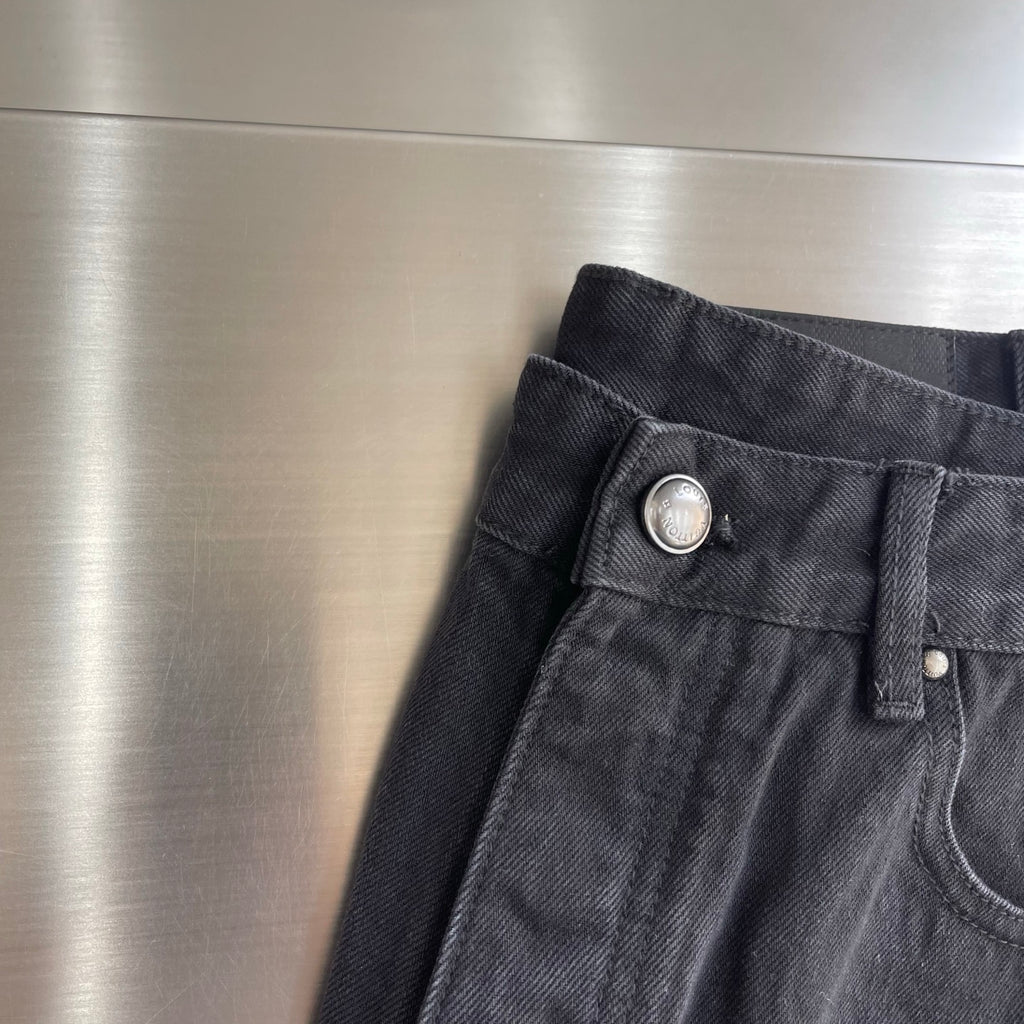 Dark denim pants waistband with metal button and front fly details