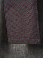 Gucci pants lower-leg close-up, maroon and gray GG-pattern woven fabric