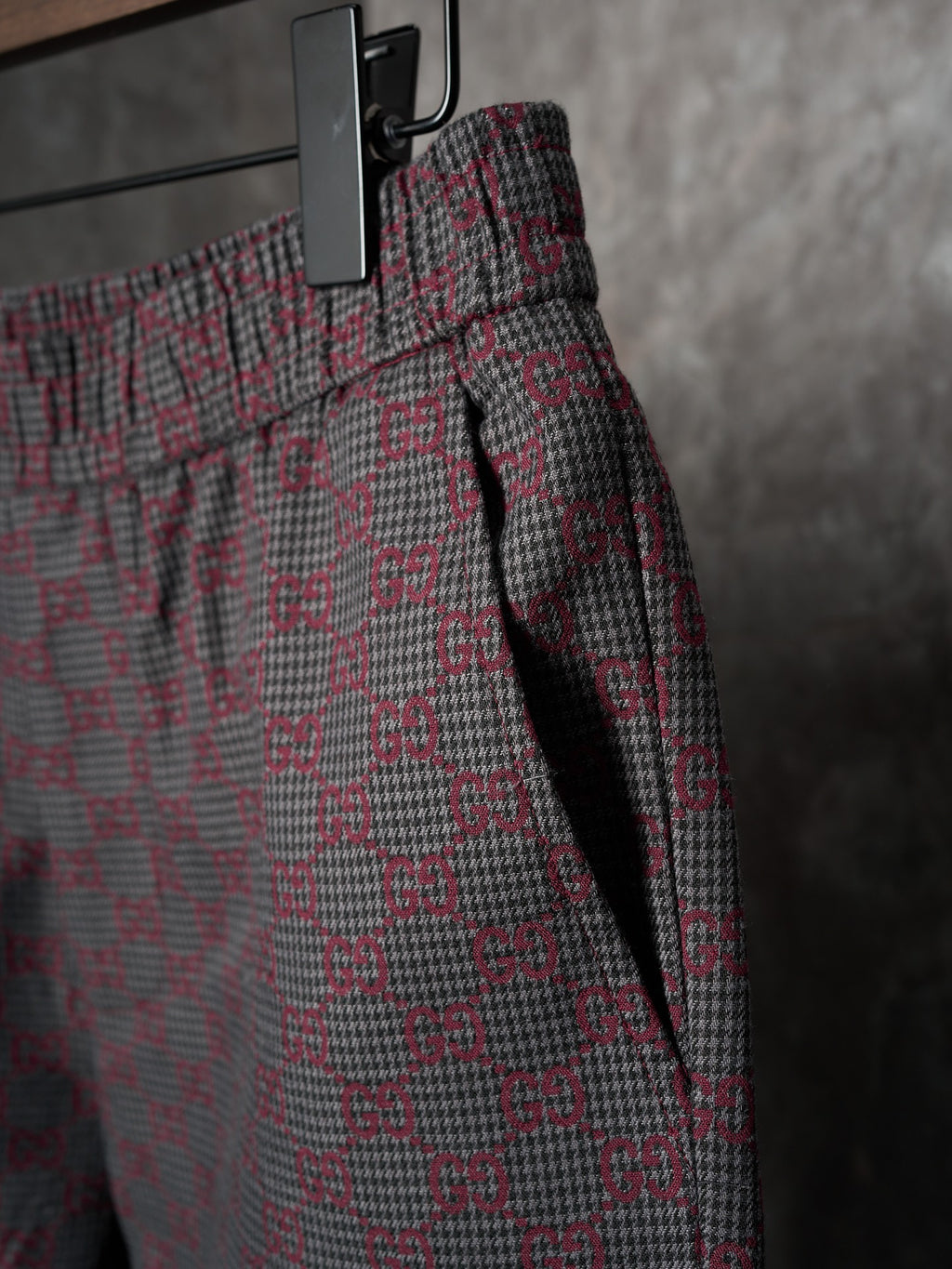 Gucci pants side view with elastic waist and drawcord, maroon/gray GG-pattern weave