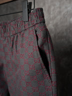 Gucci pants side view with elastic waist and drawcord, maroon/gray GG-pattern weave