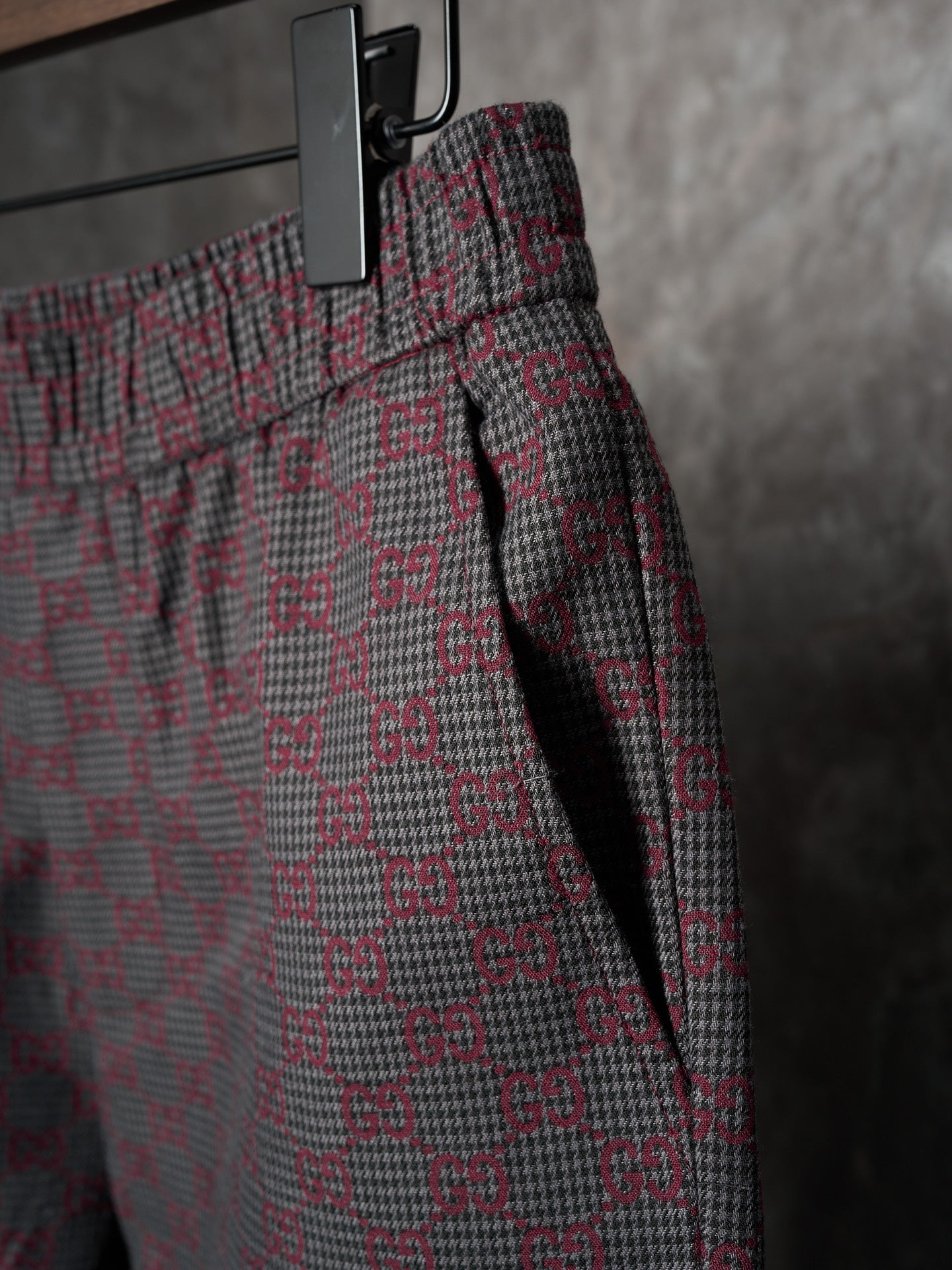 Gucci pants side view with elastic waist and drawcord, maroon/gray GG-pattern weave