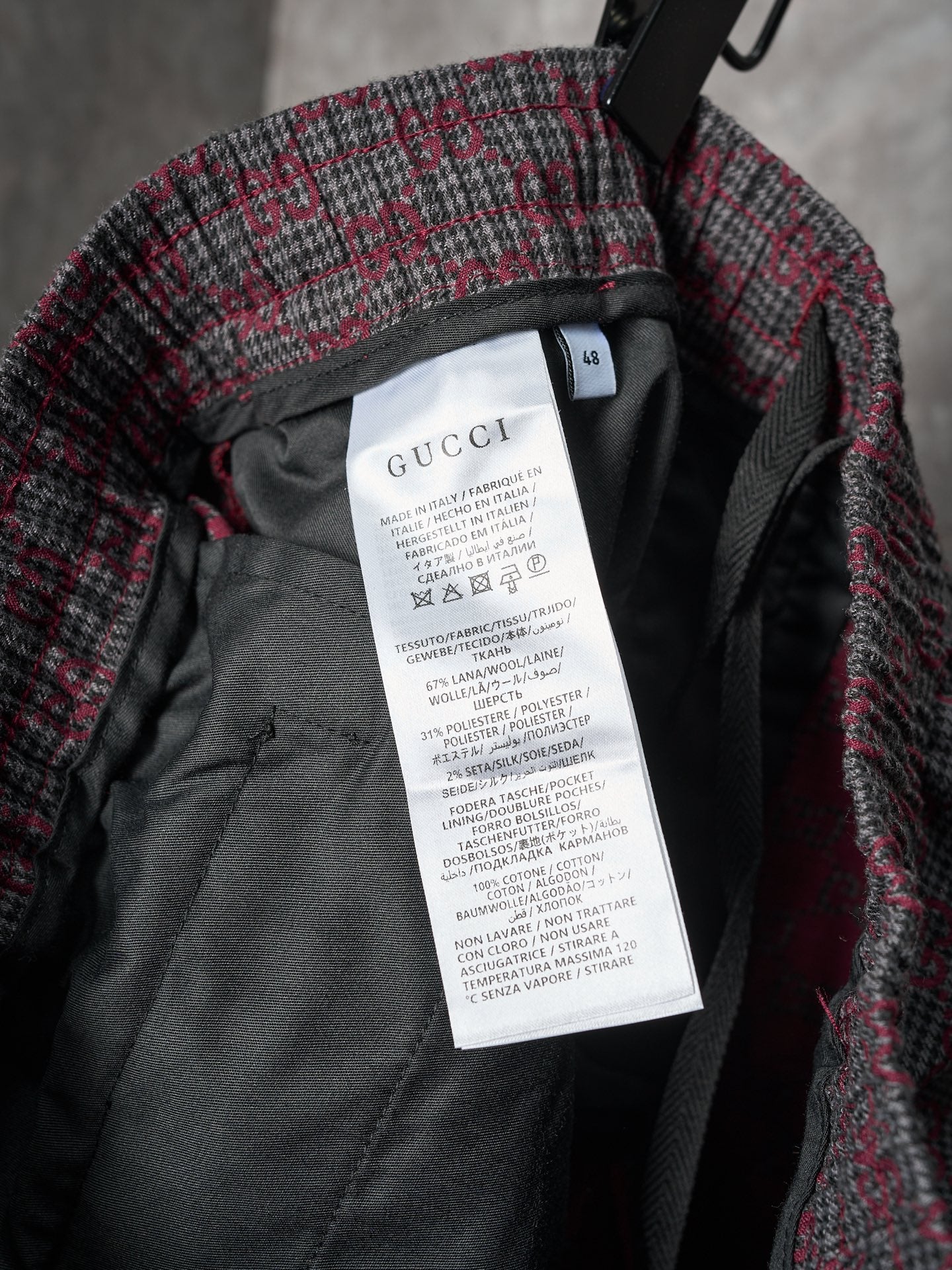 Gucci pants interior care label on black lining, GG-pattern exterior fabric