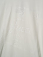 Light cream Gucci T-shirt with embossed logo and script on the chest