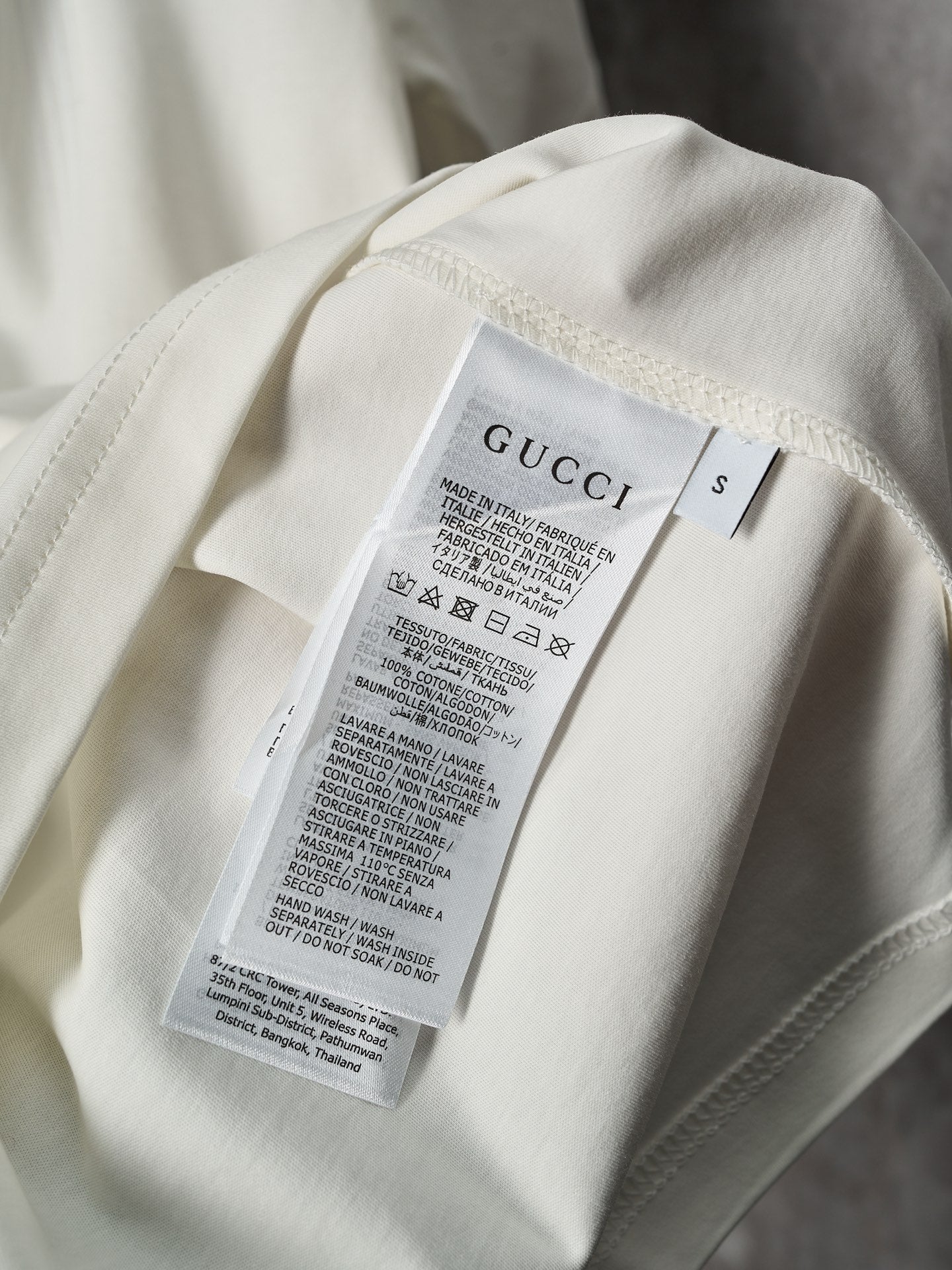 Gucci T-shirt inside care label on light cream fabric
