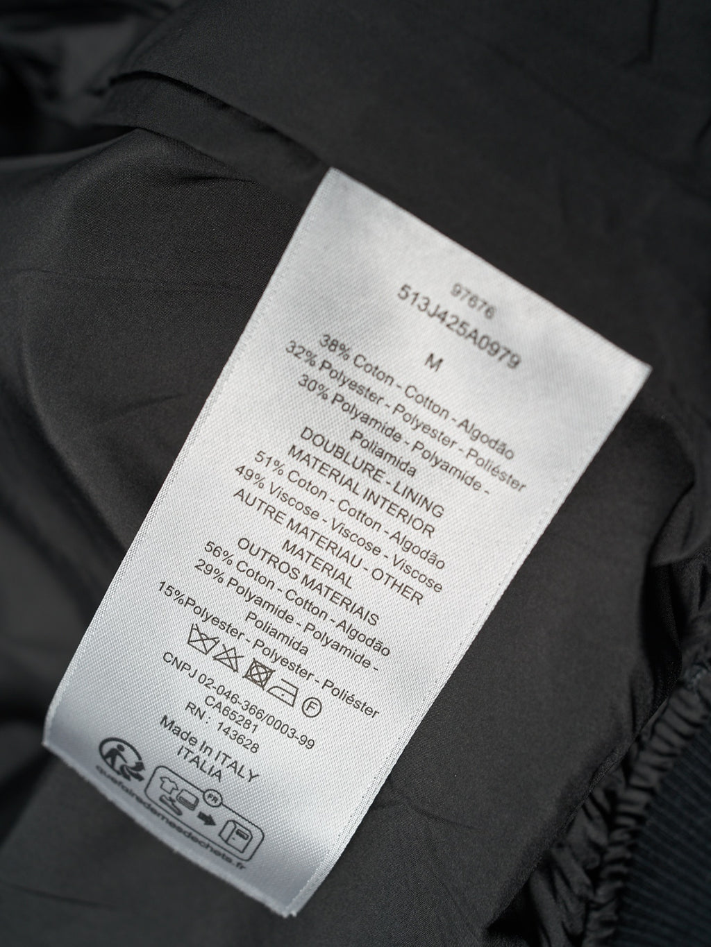 Black Dior jacket care label with material and sizing information