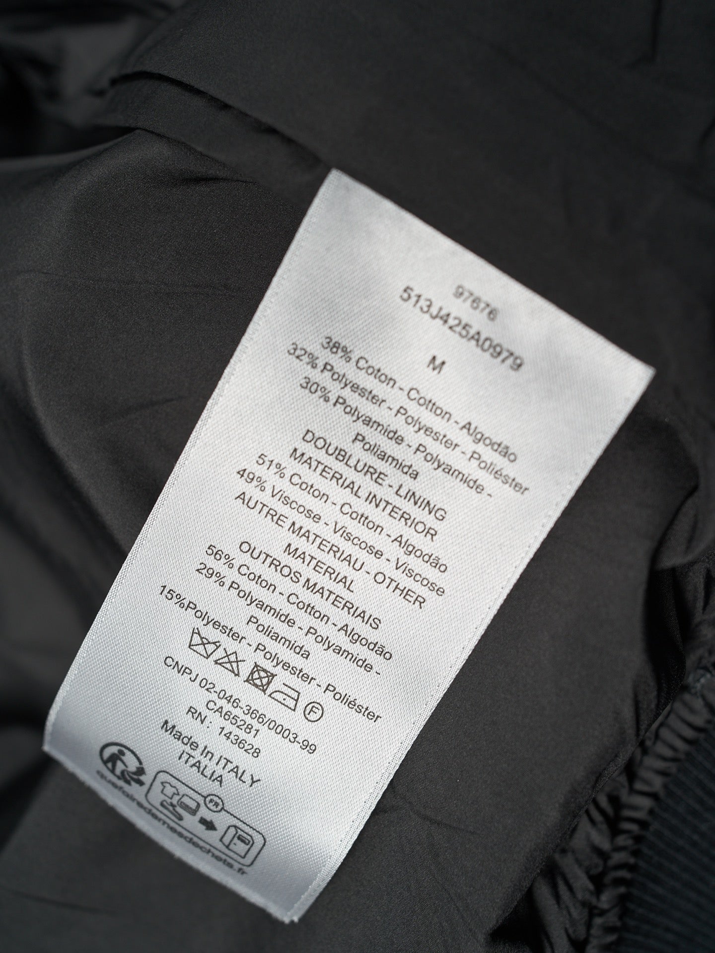 Black Dior jacket care label with material and sizing information