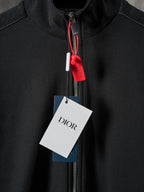 Black Dior zip-up jacket with red zipper pull and stand collar