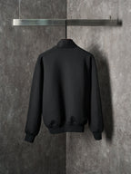 Black Dior zip-up bomber jacket, back view with ribbed hem and cuffs