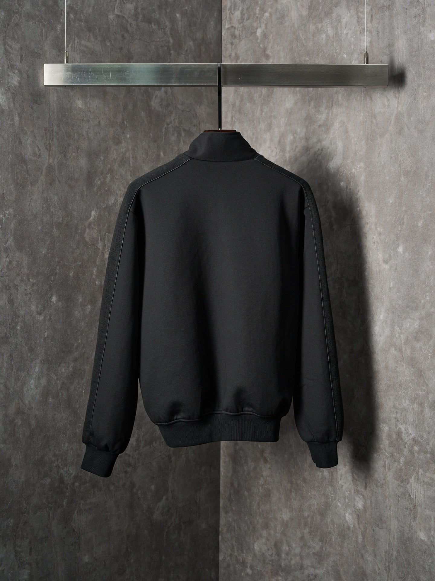 Black Dior zip-up bomber jacket, back view with ribbed hem and cuffs