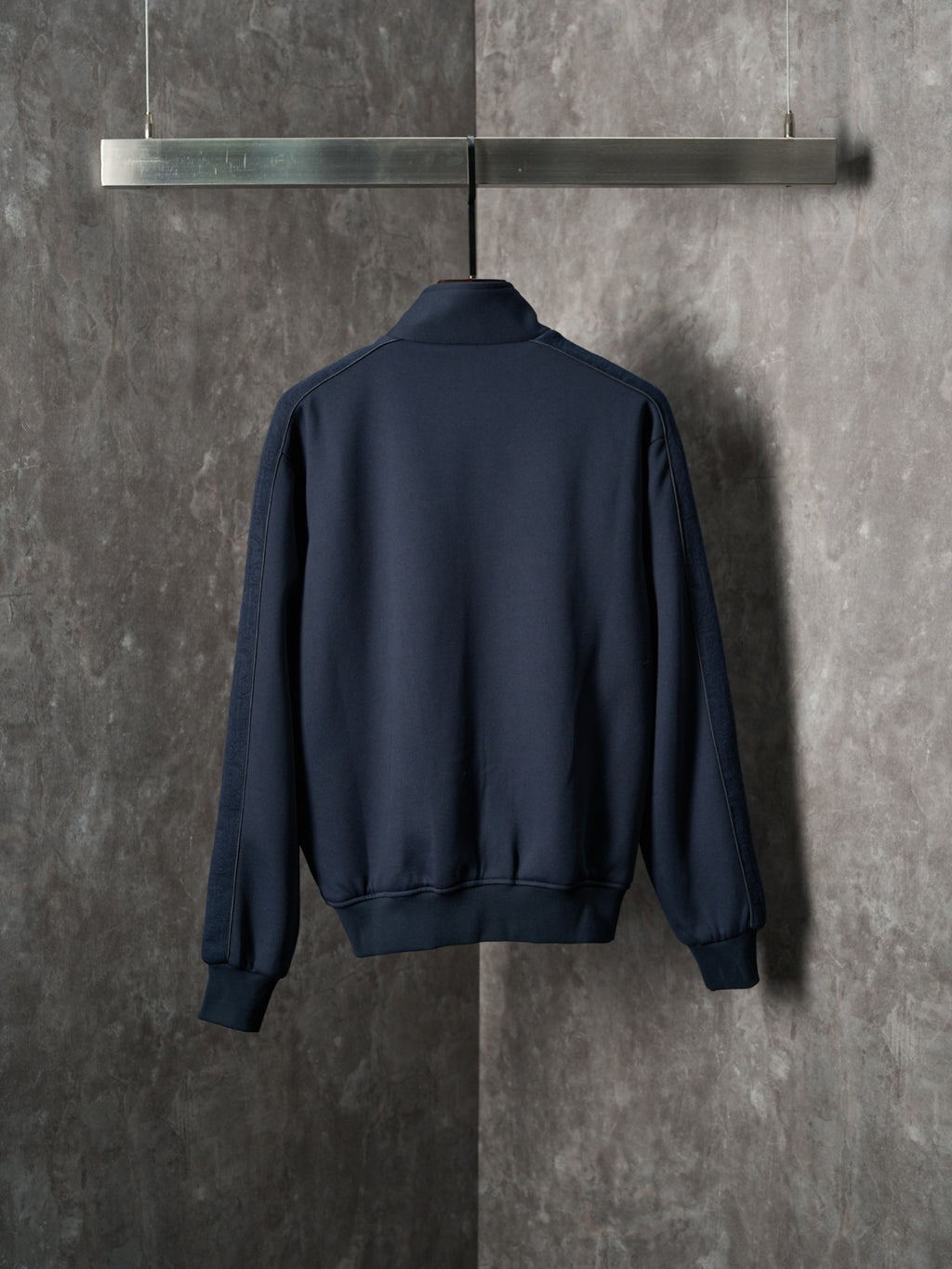 Navy back view zip-up jacket with ribbed cuffs and waistband