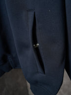 Navy jacket button placket detail on side seam pocket