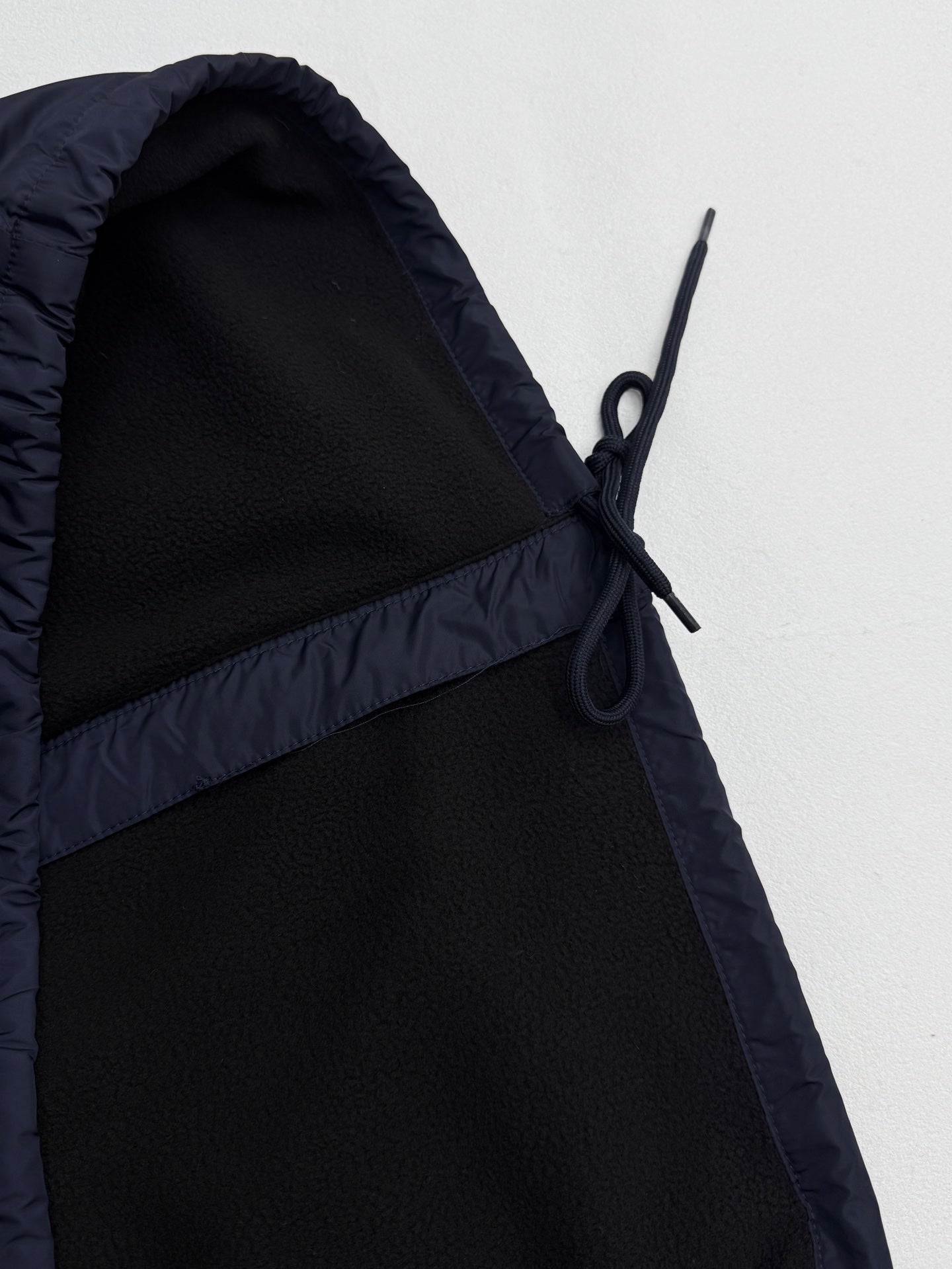 Prada dark navy jacket hood with black drawstrings and angled seam panel