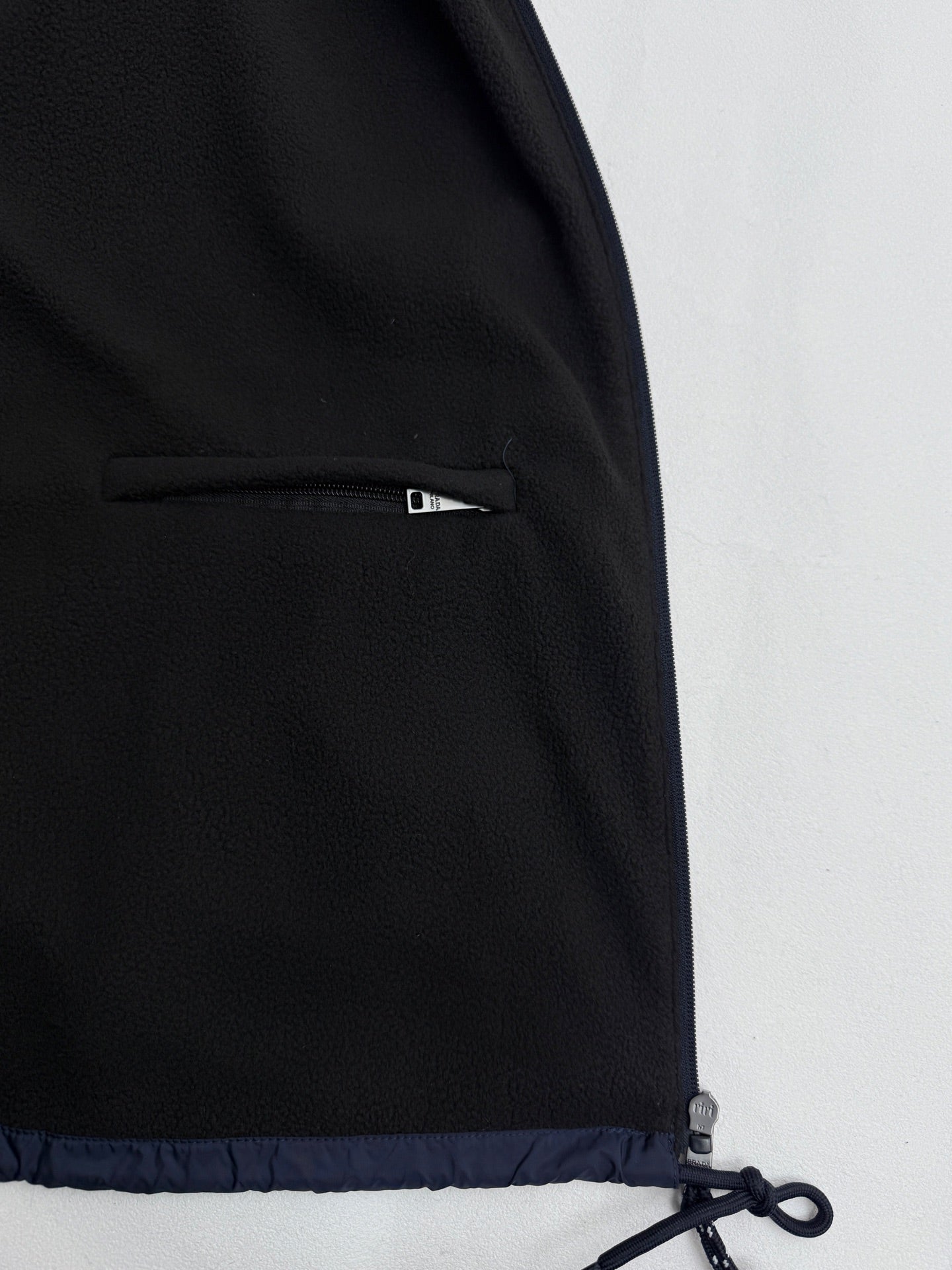 Prada dark navy jacket with side interior zipper pocket near hem