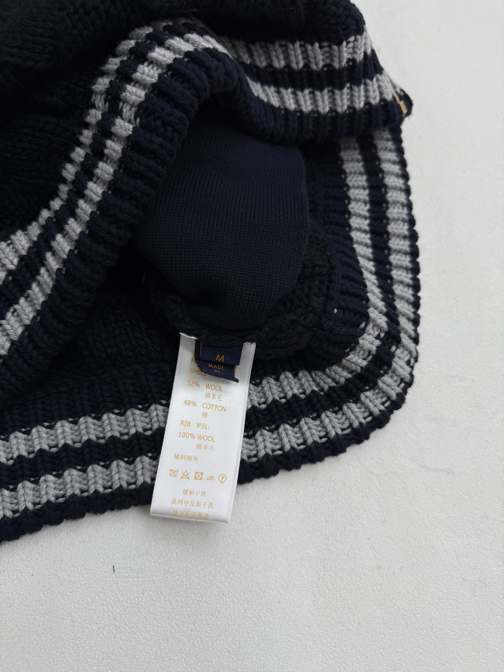 Louis Vuitton knit cardigan neckline with navy and gray striped trim and neck tag