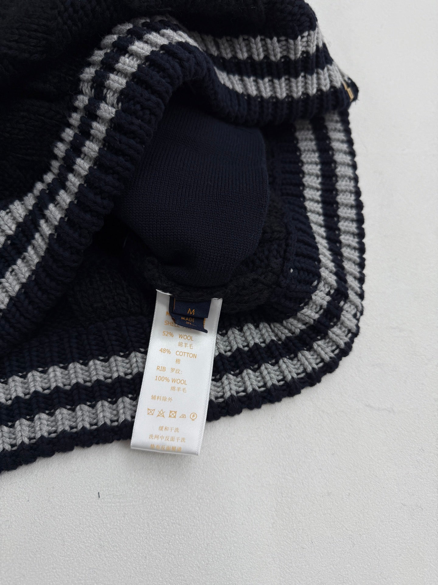 Louis Vuitton knit cardigan neckline with navy and gray striped trim and neck tag