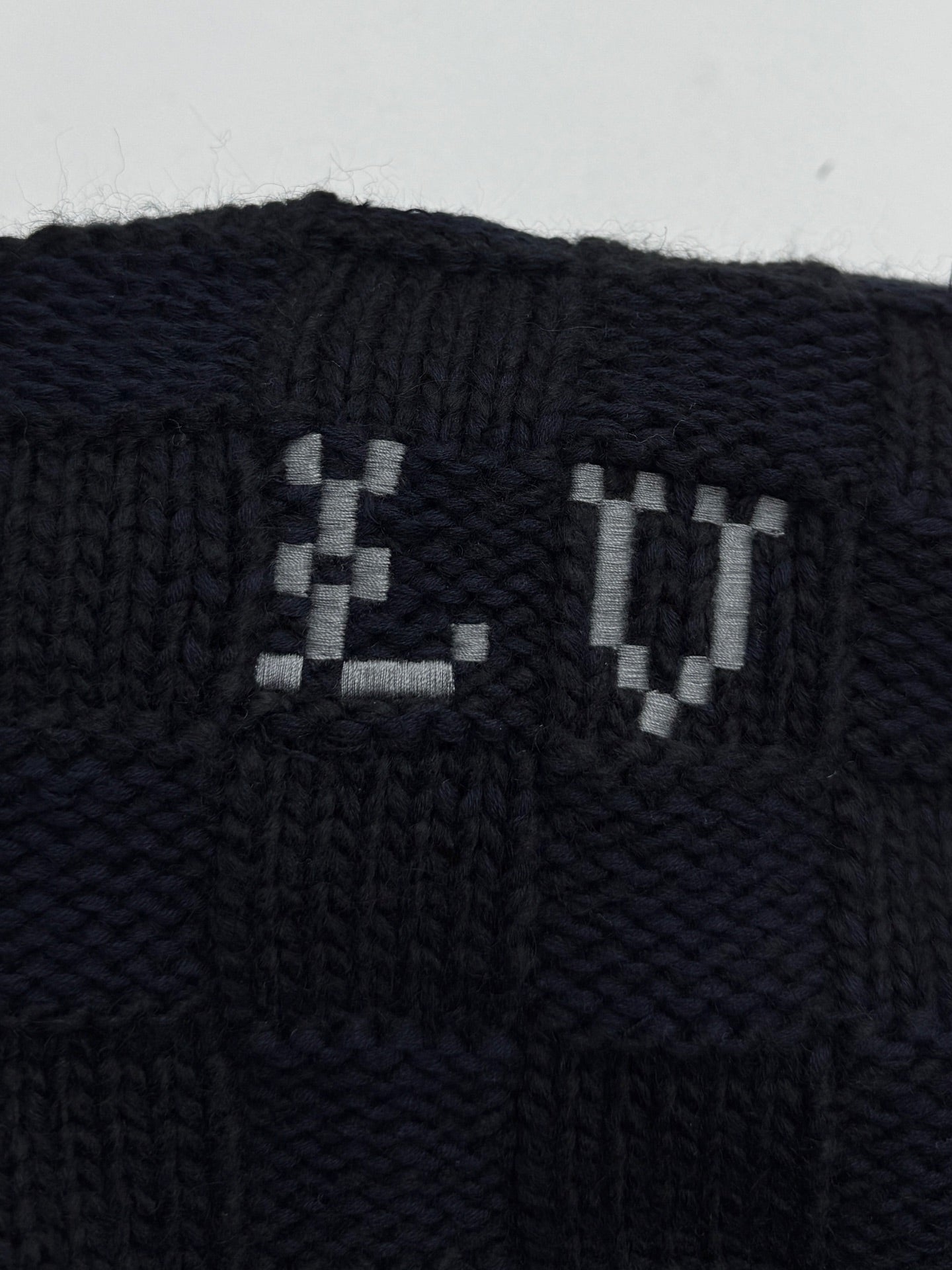 Louis Vuitton knit cardigan front with LV jacquard logo in dark navy