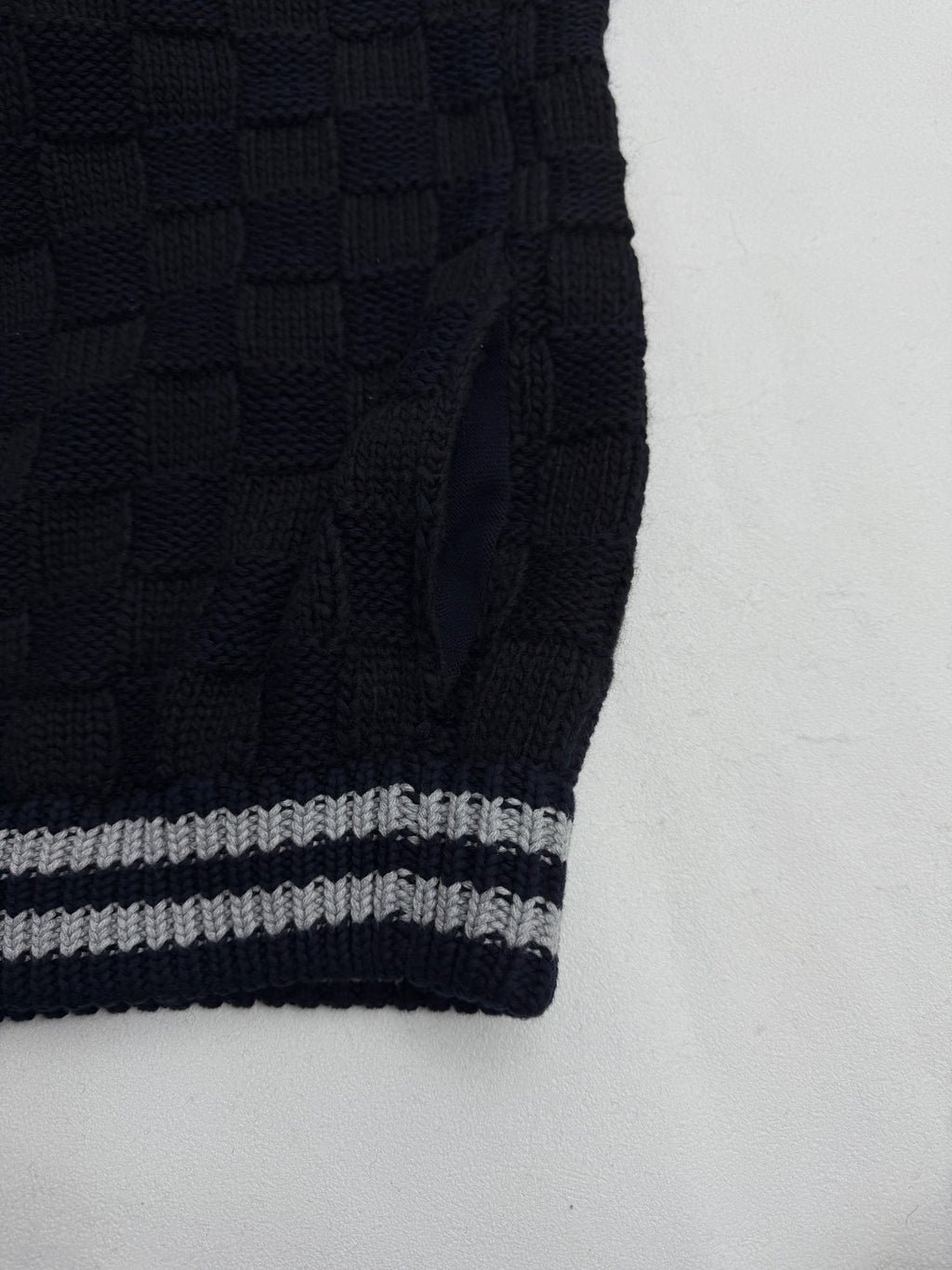 Louis Vuitton knit cardigan sleeve with navy ribbing and gray-and-white striped cuff